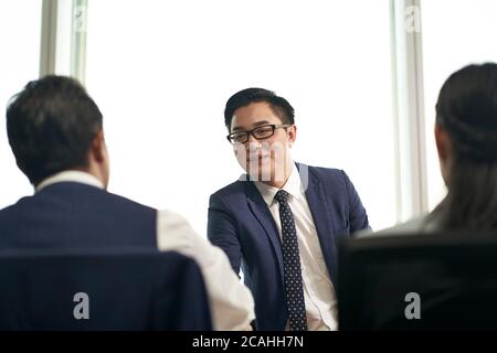young asian job seeker shaking hands with human resources manager before job interview Stock Photo
