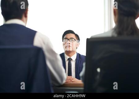 young asian business man job candidate talking to hr people during employment interview Stock Photo