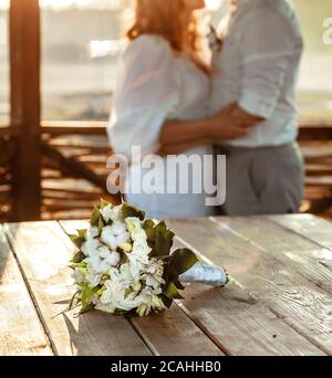 Unrecognizable young couple holding hands while having romantic date at lovely outdoor cafe Stock Photo
