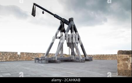 ancient catapult located on the ramparts of Alghero Stock Photo