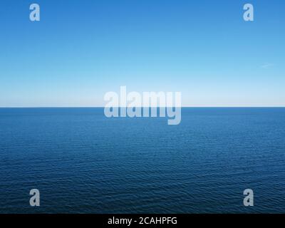 Blue horizon where the cloudless sky and the blue sea converge. Stock Photo