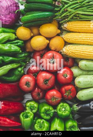vegetables on the refrigerator shelf, autumn vegetables. full of corn, tomatoes, peppers, zucchini, cabbage, lemon, vegetables. Stock Photo