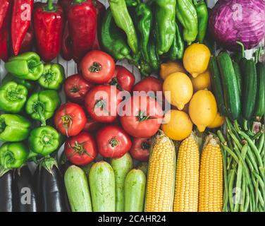 vegetables on the refrigerator shelf, autumn vegetables. full of corn, tomatoes, peppers, zucchini, cabbage, lemon, vegetables. Stock Photo
