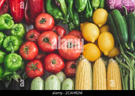 vegetables on the refrigerator shelf, autumn vegetables. full of corn, tomatoes, peppers, zucchini, cabbage, lemon, vegetables. Stock Photo