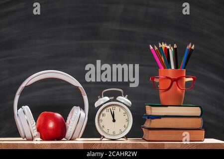 Back to school background with books and alarm clock Stock Photo - Alamy