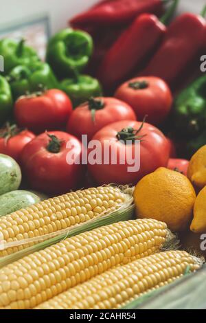 vegetables on the refrigerator shelf, autumn vegetables. full of corn, tomatoes, peppers, zucchini, cabbage, lemon, vegetables. Stock Photo