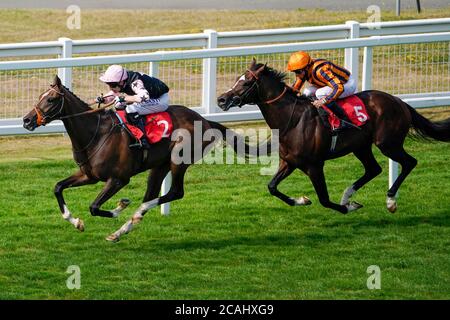 Revolver ridden by Luke Morris (left) win The Hersham Handicap at Sandown Racecourse, Surrey. Stock Photo