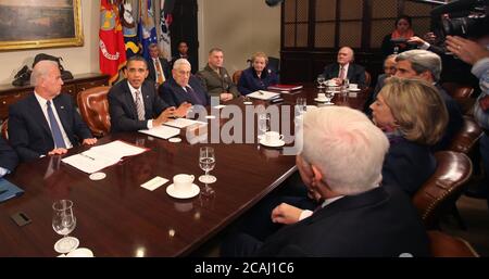 In this file photo, United States President Barack Obama makes a statement during a meeting with present administration officials and former Secrtaries of State and Defense in the Roosevelt Room of the White House on Thursday, November 18, 2010.   From left to right: US Vice President Joseph Biden; President Obama; Henry Kissinger, former US Secretary of State; General James Cartwright, Vice Chairman Joint Chiefs of Staff;  Madeleine  Albright, former Secretary of State; Brent Scowcroft, former National Security Advisor; US Senator John Kerry (Democrat of Massachusetts); US Secretary of State Stock Photo