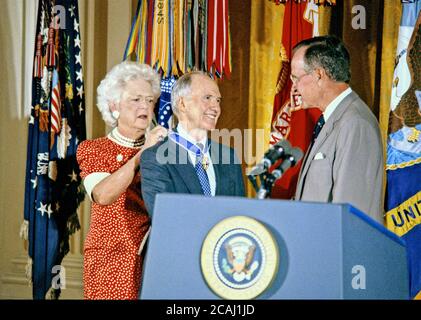 In this file photo, United States President George H.W. Bush, right, and first lady Barbara Bush, left, award the Presidential Medal of Freedom to National Security Advisor Brent Scowcroft, center, in the East Room of the White House in Washington, DC on July 3, 1991.Credit: Howard L. Sachs/CNP | usage worldwide Stock Photo