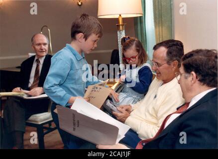 In this file photo, Bethesda, Maryland - May 5, 1991 -- United States President George H.W. Bush was greeted by two of his grandchildren, Sam and Ellie LeBlond in the Presidential Suite at Bethesda Naval Hospital in Bethesda, Maryland on May 5, 1991. The President was meeting with Chief of Staff John Sununu, right, and National Security Advisor Brent Scowcroft, left. Sam and Ellie are the children of the President's daughter, Dorothy.Credit: White House via CNP | usage worldwide Stock Photo