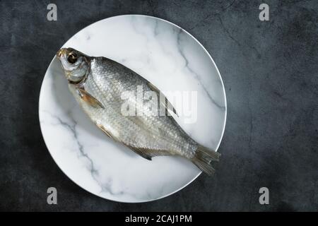 Salted and dried fish on a plate Stock Photo