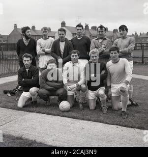 1965, historical, amateur village football team, group picture, showing the soccer kit, boots and sports clothing of the day, Bucks, England, UK. Eleven men are in the photo, but not sure why only 10 footballers are in kit or tracksuits.... Stock Photo