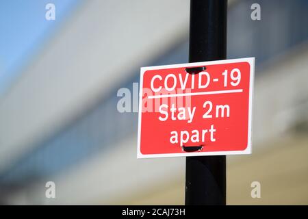 COVID - 19 Social distancing sign on a lamp post in Doncaster Stock Photo