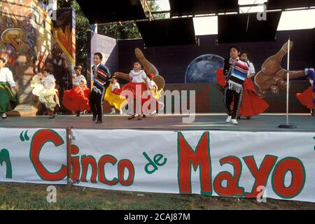 Costumed young Hispanic boys and girls dance onstage during Cinco de Mayo celebration in Austin, Texas. ©Bob Daemmrich Stock Photo