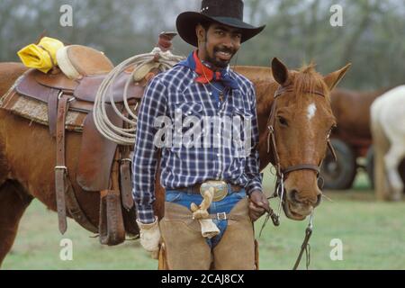 Black cowboy walking with horse in Missouri City, Texas. ©Bob Daemmrich Stock Photo