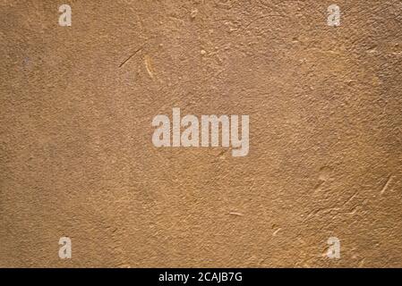 Blurred golden brown plaster wall. Backgrounds and textures. Stock Photo