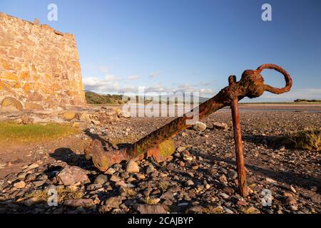 Old rusty anchor on the beach at Ravenglass, Lake District, England Stock Photo
