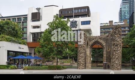 Alongside the ruin of the Tower of St. Elsyng Spital,people dine al fresco at the Barbie GREEN Aussie cafe/restaurant, London Wall, Barbican, London Stock Photo