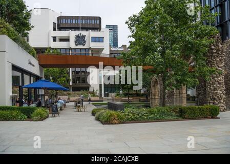 Alongside the ruin of the Tower of St. Elsyng Spital,people dine al fresco at the Barbie GREEN Aussie cafe/restaurant, London Wall, Barbican, London Stock Photo