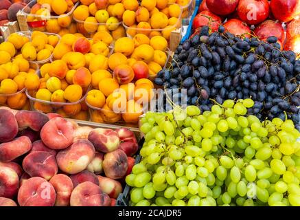 Grapes, peaches and plums for sale at a market Stock Photo