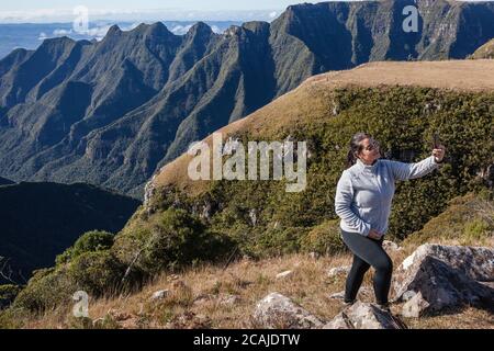 Woman taking a selfie of the cliffs of Ronda Canyon - Bom Jardim da Serra - SC - Brazil Stock Photo