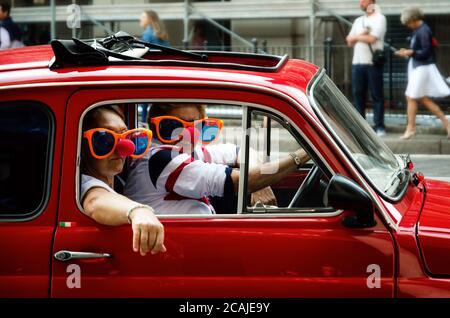 TURIN, ITALY - SEPTEMBER 24, 2017 - Funny looking couple driving an old red Fiat 500 during a classic car rally in Turin (Italy) on september 24, 2017 Stock Photo