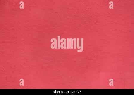 Bright rough plastered surface. Living coral colored. Backgrounds and textures. Stock Photo