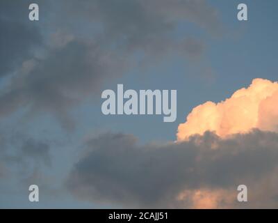 Beautifully sunlit cumulus and stratocumulus clouds forming what may become a thunderstorm -05 Stock Photo