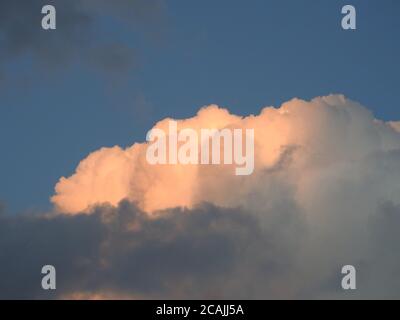 Beautifully sunlit cumulus and stratocumulus clouds forming what may become a thunderstorm -06 Stock Photo