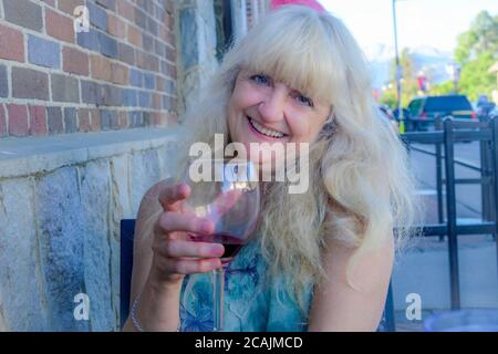 Happy smiling woman with glass of red wine Stock Photo