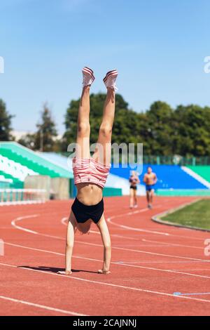 Girl teenager walks in her arms at the stadium. Concept on the topic of a healthy lifestyle Stock Photo