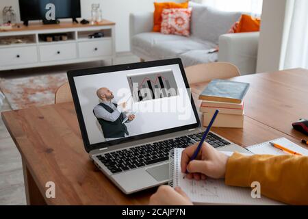 student or freelancer working with distance learning from home at a leptop. Stock Photo