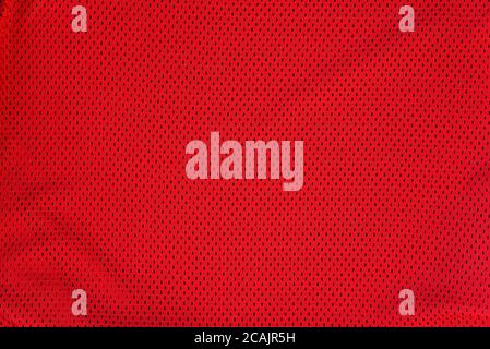 Textured bright red mesh fabric. Stock Photo