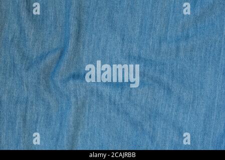 Crumpled denim seamless fabric texture. Dark blue color Stock Photo
