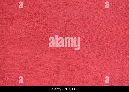 Bright rough plastered surface. Living coral colored. Backgrounds and textures. Stock Photo