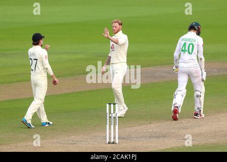 England's Ben Stokes (centre) celebrates the wicket of Pakistan's Shaheen Shah Afridi with Rory Burns during day three of the First Test match at the Emirates Old Trafford, Manchester. Stock Photo