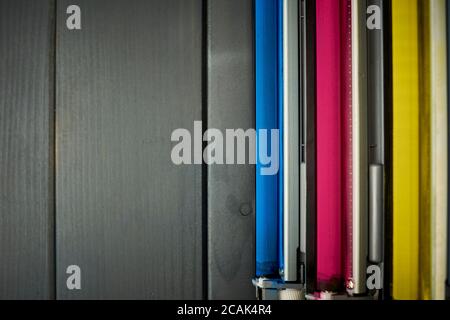 Top view of rollers in a set of laser printer color cartridges on gray wooden background Stock Photo