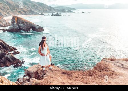 Pregnant couple posing on the Loiba cliffs in Galicia, Spain Stock Photo