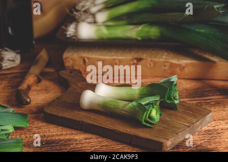 Fresh green leek on cutting board Stock Photo