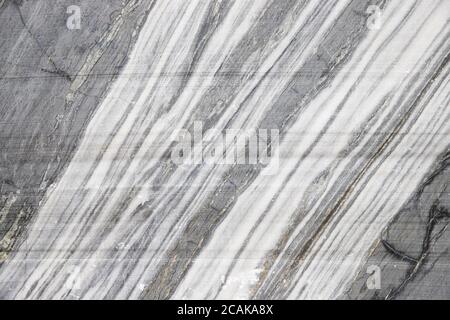Extraction of blue marble. Marble quarry closeup.Mining industry. White marble texture in opencast mine. The surface of the marble rock Stock Photo