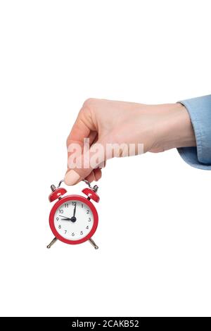 Red alarm clock in a female hand. Isolate on white background. Stock Photo