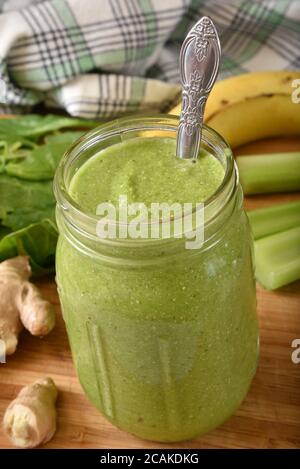 A smoothie made with spinach, arugula, ginger, celery, banana, apple and quinoa for health Stock Photo