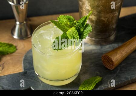 Boozy Refreshing Chartreuse Smash with Mint and Lemon Stock Photo
