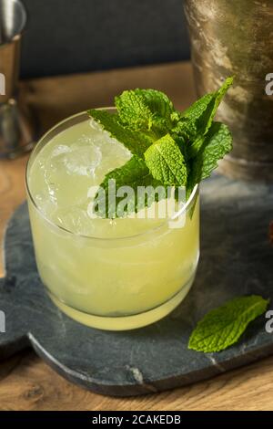 Boozy Refreshing Chartreuse Smash with Mint and Lemon Stock Photo