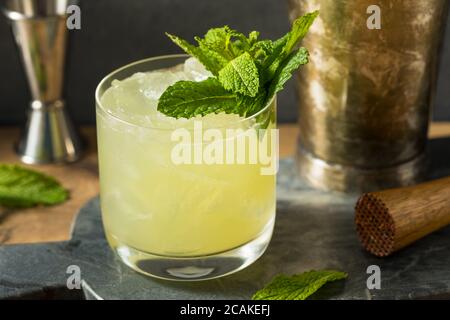 Boozy Refreshing Chartreuse Smash with Mint and Lemon Stock Photo