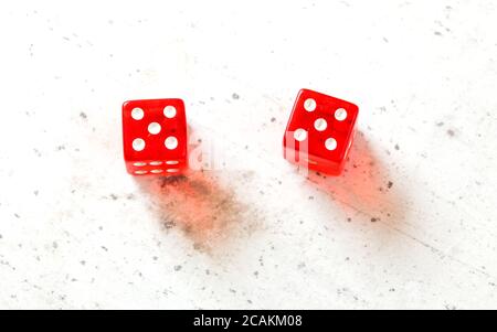 Two red craps dices showing Hard Ten (double number five) overhead shot on white board Stock Photo