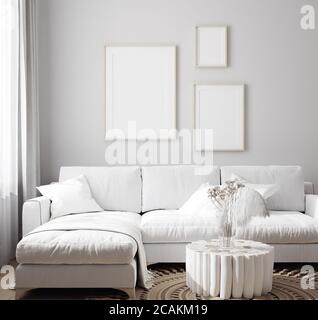 White sofa with decor and mockup frames on wall in Scandinavian style interior, 3d render Stock Photo