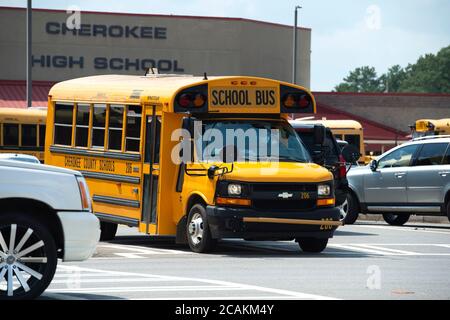 Canton, GA, USA. 7th Aug, 2020. Cherokee High School buses leave school with students at end of first week of in-person fall classes during pandemic worries. The school system mandate masks for all faculty and staff, but declined to insist students wear them. Administrators admitted the county is under a Ã”national microscopeÃ as it reopened face-to-face classes as Covid-19 cases surged in Georgia. Credit: Robin Rayne/ZUMA Wire/Alamy Live News Stock Photo