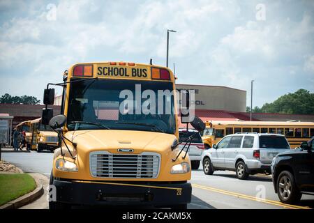 Canton, GA, USA. 7th Aug, 2020. Cherokee High School buses leave school with students at end of first week of in-person fall classes during pandemic worries. The school system mandate masks for all faculty and staff, but declined to insist students wear them. Administrators admitted the county is under a Ã”national microscopeÃ as it reopened face-to-face classes as Covid-19 cases surged in Georgia. Credit: Robin Rayne/ZUMA Wire/Alamy Live News Stock Photo