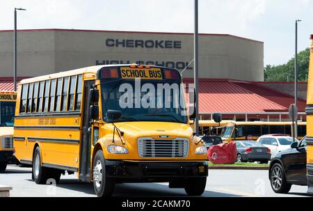 Canton, GA, USA. 7th Aug, 2020. Cherokee High School buses leave school with students at end of first week of in-person fall classes during pandemic worries. The school system mandate masks for all faculty and staff, but declined to insist students wear them. Administrators admitted the county is under a Ã”national microscopeÃ as it reopened face-to-face classes as Covid-19 cases surged in Georgia. Credit: Robin Rayne/ZUMA Wire/Alamy Live News Stock Photo